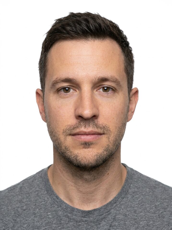The passport photo made from it: the same man, same t-shirt, facing the camera on a plain white background.
